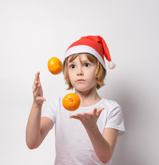 Little girl juggling tangerines