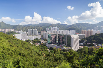 View of Sha Tin (Shatin) District surrounded by lush hills and mountains in Hong Kong, China.
