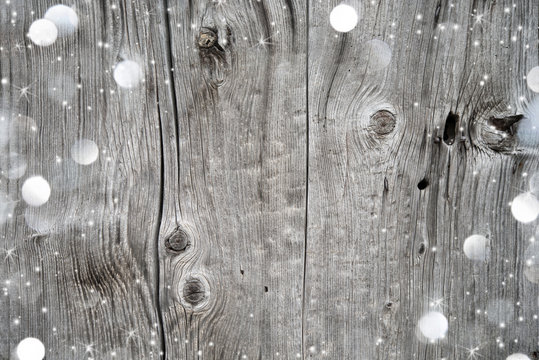 Christmas background with snow and lights on wood