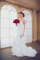 Portrait of Young Beautiful Attractive Bride with Flowers. White Dress and Wedding Decorations. Vintage Toning