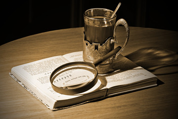 Still Life "Thinking about the Sherlock Holmes". The opened book in Russian on a short story "The Adventure Of The Dancing Men" by Sir Arthur Conan Doyle