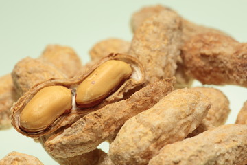 salted peanuts on white background
