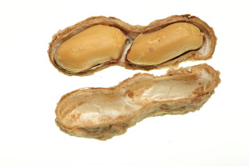 salted peanuts on white background
