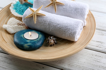 Marine style spa composition in a bowl on wooden background