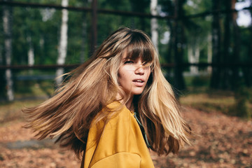 girl with beautiful hair turns around and looks at the camera