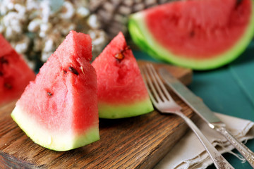 Sliced watermelon on decorated wooden background