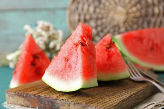 Sliced watermelon on decorated wooden background