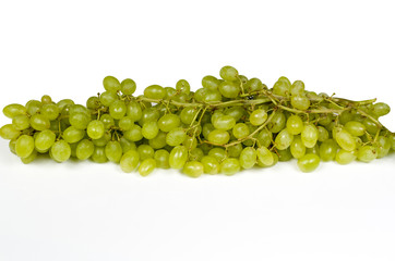 lying bunch of large oblong green-yellow ripe grapes on a white table  Close-up on full frame isolated on white background