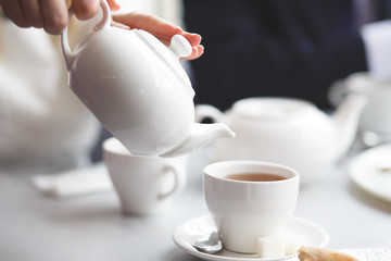 female pouring tea