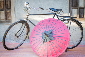 Old vintage bicycle and paper umbrella