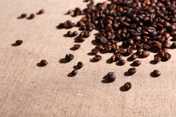 Roasted coffee beans on the linen fabric
