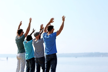 Young men on the riverside