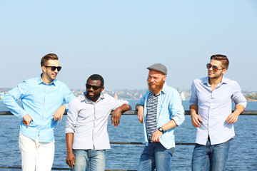 Young men relaxing on the riverside