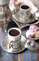 Antique tea-set with Turkish delight on table close-up