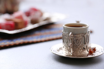 Antique tea-set with Turkish delight on table close-up