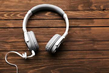 Headphones on brown wooden background