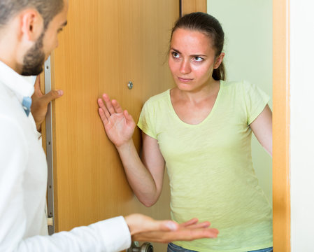 Man And Woman Talking At The Door