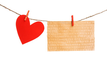 Paper heart and empty sheet hang on cord isolated on white background