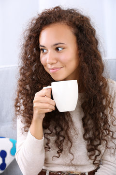 Close up portrait of pretty young women drinking coffee on white background