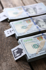 Packs of American dollars, on wooden background. Saving concept