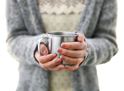 Hand holding coffee cup, outdoors