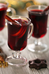 Mulled wine on wooden table, close-up