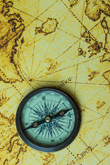 Fototapeta na wymiar vintage lifestyle concept: retro compass on antique world map
