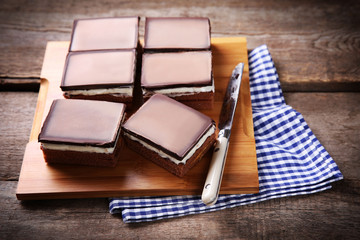Delicious chocolate brownies on wooden background