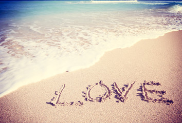 Love inscribed in the sand of a beach