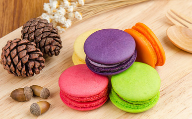 Tasty Sweet Macaroons on wooden background.