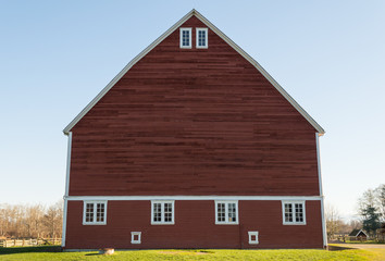 Unique red barn with green grass and blue sky © trac1