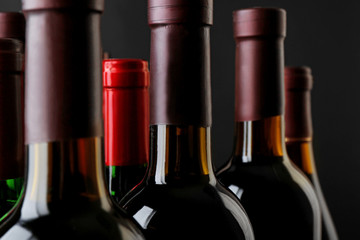 Wine bottles neck on dark background, close up