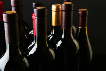 Wine bottles neck on dark background, close up