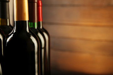Wine bottles on wooden background, close up