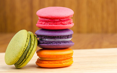 Tasty Sweet Macaroons on wooden background.