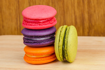 Tasty Sweet Macaroons on wooden background.