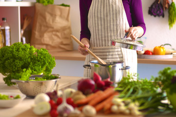 Young Woman Cooking in the kitchen. Healthy Food