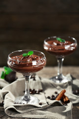 Chocolate dessert in glasses on wooden background