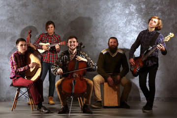 Musical band on grey wall background