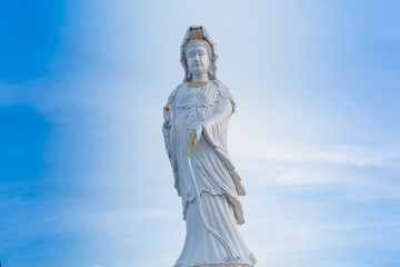 Fototapeta na wymiar Guanyin Buddha statue on blue sky