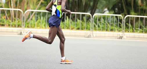 Marathon runner running on city road