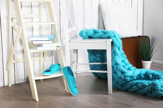 Knitted woolen blanket on stairs, on home interior background