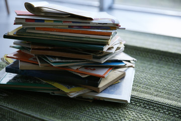 Pile of books on window board, close up