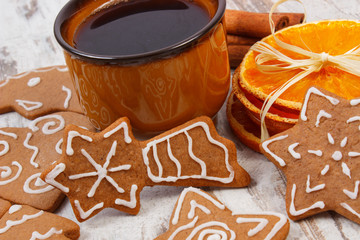 Fresh gingerbread, cup of coffee and spices on old wooden background, christmas time