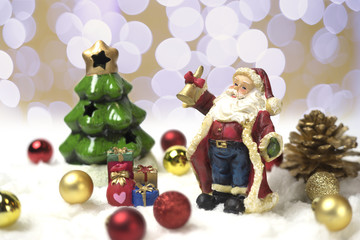 Obraz na płótnie Canvas Santa Claus stands on snow with his hand bell.
