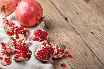 Pomegranate slices on a wooden table