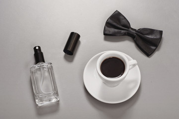 Black coffee with a bow tie and eau de toilette