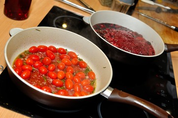 Cherry tomatoes cooking in pan, closeup