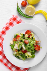 Tasty salmon salad on light wooden background