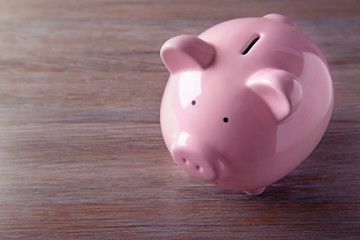 Pig moneybox on wooden background